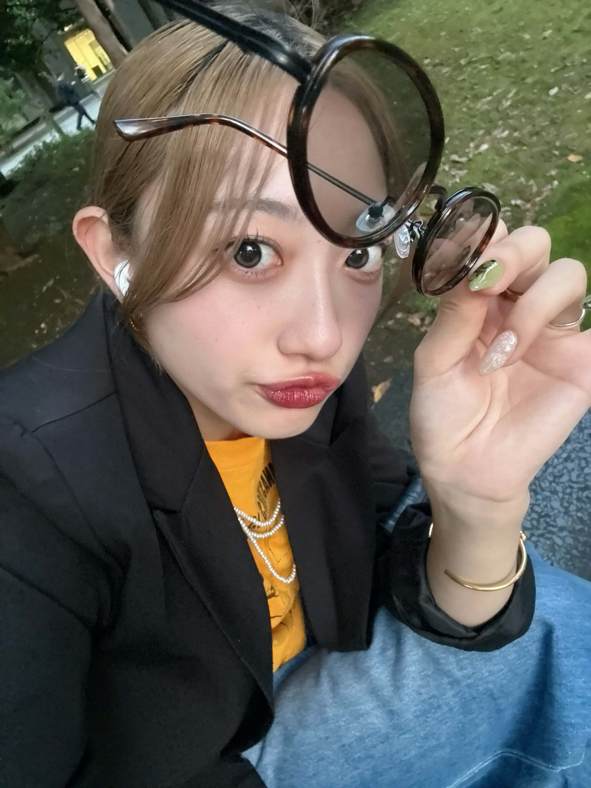 Knot bangle ゴールドを着用したブラックジャケットとデニムのコーデ