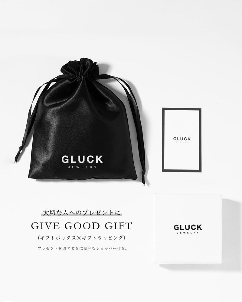 GLUCK(グルック)のGeminiリング用ギフトラッピングセット。黒い巾着袋、白いギフトボックス、ブランドロゴ入りショップカードが並ぶ様子